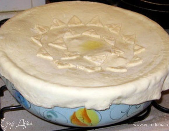 За эти 10 минут раскатать тесто в круг диаметром чуть больше формы, украсить его. Я просто нарезала обрезки теста на треугольнички и выложила их на круг из теста, смазав белком, чтобы они приклеелись.
Достать форму из духовки и накрыть её тестом, сделать в центре дырочку. Смазать яйцом или молоком. Вернуть в духовку ещё минут на 15 или пока тесто не подрумянится.

