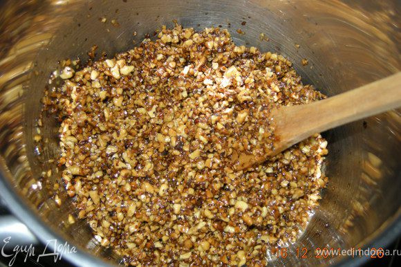 Ставим мед на огонь и добавляем орехи. Помешиваем деревянной ложкой минут 10. В конце добавляем сахар и снимаем с огня.