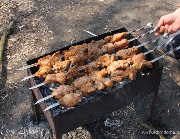 Теперь никуда от мангала!!! --- Подготовьте пластиковую бутылку с водой. Заверните крышку, сделав предварительно в ней отверстие для возможности полива воды струйкой. Положите шампуры таким образом, чтобы вы легко могли переворачивать их. Если какой-то шампур плохо лежит из-за того, что куски мяса перевешивают с одной стороны, переназизайте мясо. Лучше, если вы будете переворачивать мясо в одну сторону, Переворачивайте каждые 15 секунд. Как только через несколько оборотов шампуры сместятся в сторону переложите последний шампур на освободившееся место. Таким образом вы добьетесь равномерного прогревания, даже если угли не достаточно равномерно распределены. Если вы часто и равномерно переворачиваете мясо, языки пламени будут появляться нечасто. Если все же они появились не обращайте внимание на небольшие вспышки в пару секунд. А вот если пламя будет гореть в течение секунд пяти, залейте его струёй из бутылки, но непременно только на угли, а не на мясо. Полив мясо вы добьетесь прямо противоположного эффекта, во-первых у жир и соки смоются водой на угли, что сделает мясо более сухим, во-вторых, после испарения воды, жир обязательно загорится.