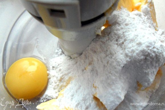 Соединить сливочное масло, сахарную пудру и желток, растереть с помощью комбайна секунд 30.