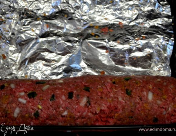 Начиная с краев и держа фольгу тихонько сворачивать рулетом туго  фарш итак до конца,при этом фольга свободно после заворачивая рулета выходит из него.