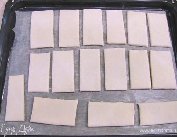 Положите бумагу для запекания на противень и смажьте сливочным маслом (можно насыпать прямо на противень манную крупу без бумаги и класть сверху язычки). Переложите язычки на противень.