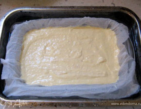 Приготовить вторую форму чуть больше первой по размеру. Налить в неё немного воды (водяная баня).
Вставить меньшую форму в большую и выложить творожную массу в форму на бумагу для выпечки. Разровнять.
