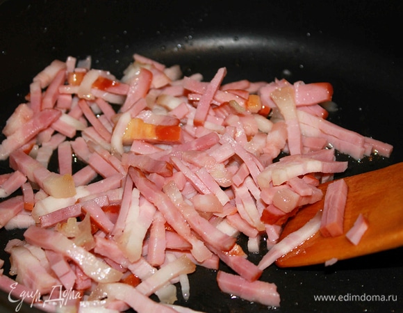 На среднем огне обжарить бекон, минут 5 примерно. Добавить к бекону лук и готовить, часто помешивая, 6 минут.