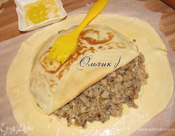 Выкладываем грибную начинку, укрываем блином, слегка придавливаем и промасливаем блин.