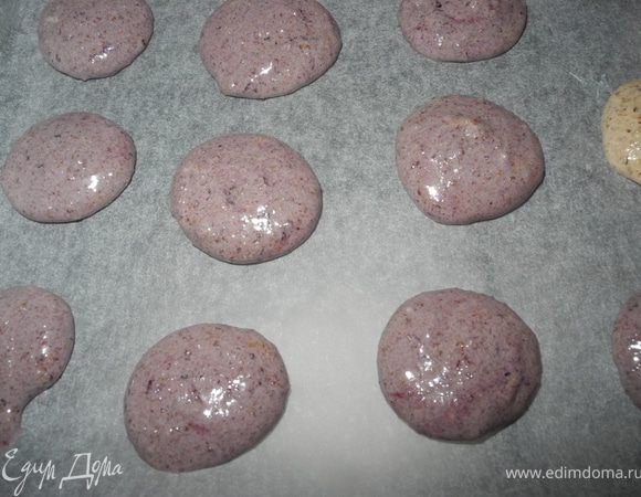С помощью чайной ложки или кондитерского мешка отсадить печенье на противень, застеленный пергаментной бумагой.
У меня на фотке печенья с добавлением голубичного джема, поэтому они такие сиреневые, но мне они не очень понравились, так как растеклись и стали плоскими, а просто ореховые печеньки в этот кадр не попали, но принцип формовки один и тот же.
