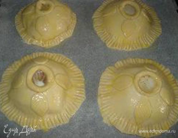 Из остатков теста вырезать листики. Смазать рыбу в тесте желтком и украсить листиками теста, снова смазать желтком.