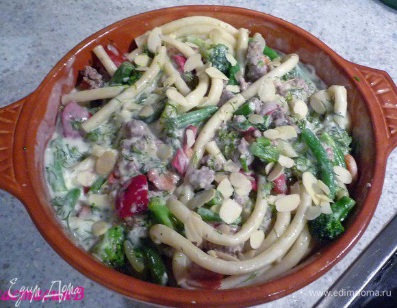 Разогреть духовку до 200°C. Выложить маккарони, фарш с овощами и соус в форму для запекания. Сверху посыпать тонконарезанным миндалем. Запечь в течение 30минут.