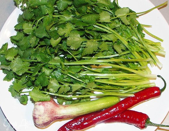 Острый перчик очистить от семян,промыть под прохладной водой и нарезать мелкой соломкой.Измельчит промытую и высушенную кинзу и чеснок.Лук порезать и залить в мисочке на 10 мин. лимонным соком.Помидорки порезать на 4-8 частей.