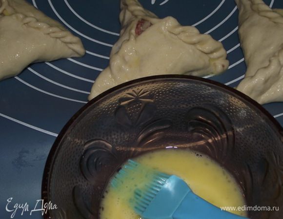 Беру 1 яйцо и смазываю Учпочмаки,сверху посыпаю кунжутом 