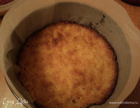 Бока разъемной формы обернуть бумагой для выпечка. На дно выложить  песочный корж.