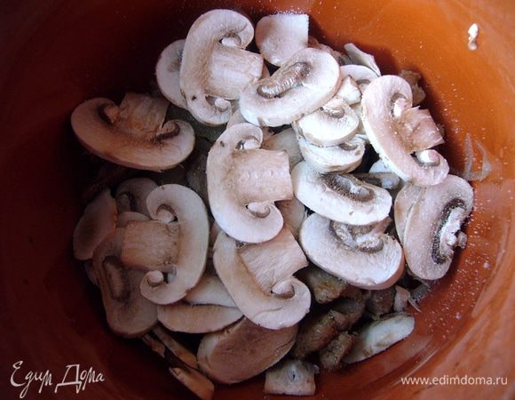 Грибы нарезаем тонкими пластиками, выкладываем поверх мяса.