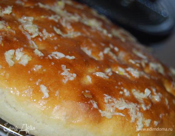 Выкладываем фокаччу на решетку и горячей смазываем чесночным соусом.