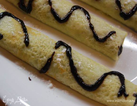 Присыпаем блины сахарной пудрой,поливаем произвольно темным шоколадом