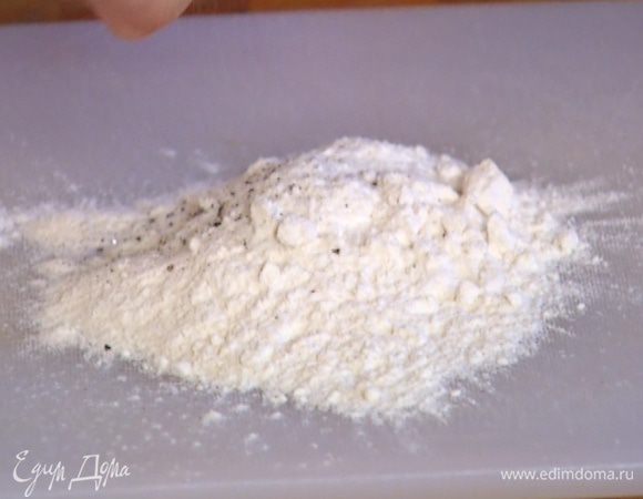 Муку высыпать на рабочую поверхность, добавить 1 ч. ложку соли и щепотку перца, все перемешать.