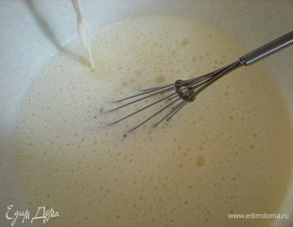 Теперь хорошо подогретое молоко (но не кипяток, градусов 40–45) потихоньку начинаем вливать в яичную массу. И интенсивно размешиваем...