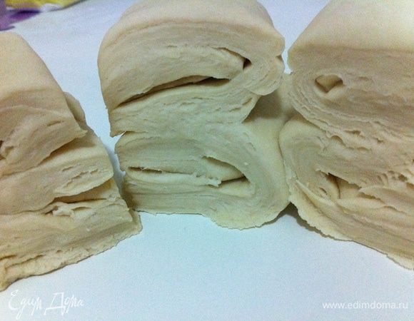 Домашнее тесло разделить на 2 части. Из одной части раскатать пласт, а вторую вернуть в холодильник. 