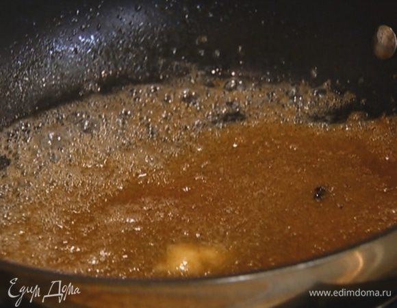 Разогреть в тяжелой сковороде сливочное масло, всыпать оставшийся сахар и дать ему раствориться.