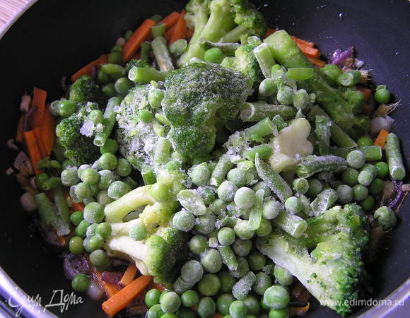 влить соевый соус, добавить зеленые овощи (у меня замороженные), перемешать, накрыть крышкой, 