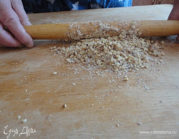 Грецкие орехи подсушить в микроволновке на полной мощности полторы минуты. Растолочь их скалкой , посыпая сахарным песком.