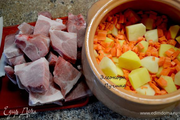 Беру большой глиняный горшочек.На дно нарезаю картошку,затем морковку кубиком,свиное мясо,наливаю кипятка до середины продуктов.Ставлю в духовку,довожу до полу-готовности.