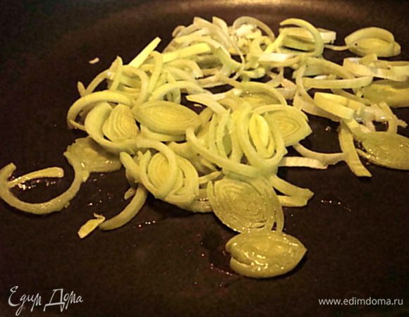 Грибы почистить или помыть, обсушить. Нарезать крупными кусками.
Лук порей порезать кольцами и поджарить до золотистости на оливковом масле на хорошо разогретой сковороде.
