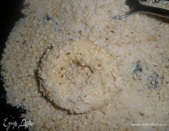 Тесто разделить на равные части. Скатать жгутики и соединить их в колечки. Обвалять их в сахарно-ореховой смеси, слегка придавлива - так больше прилипнет)