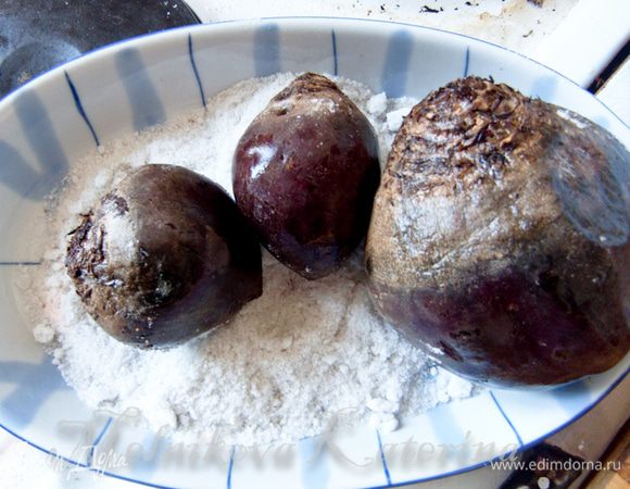 Сперва промыть свеклу, кожуру не снимать. Засыпать форму для запекания солью, выложить свеклу. Запекать в духовке в течение двух часов.