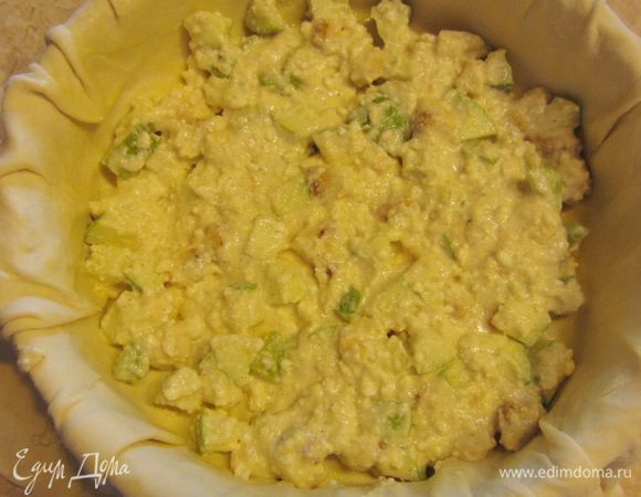 Выложите третью часть начинки в сковороду и разровняйте ее.