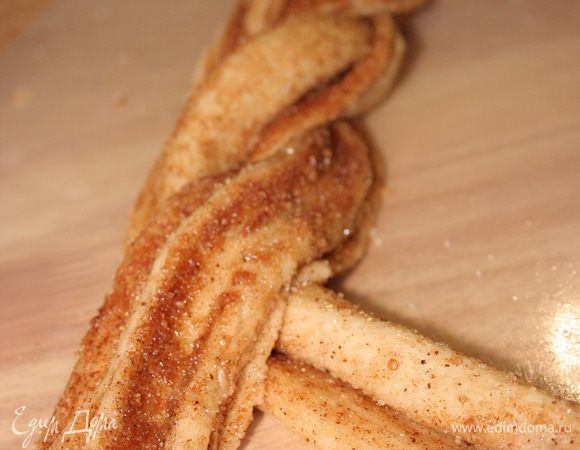 Половинки слегка выворачиваем наизнанку. Начинаем заплетать косичку, перекручивая друг с другом два конца.