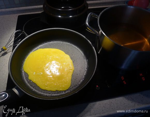 На смазанной растительным маслом сковороде на медленном огне "печем" блинчик из желтков. Рядом в кастрюле бульон для куксу.