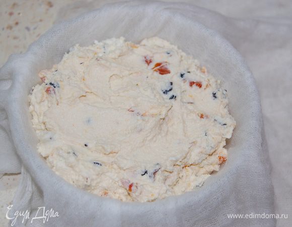 Форму выстелить несколькими слоями влажной марли. Переложить творожную массу, утрамбовать, накрыть марлей. Сверху поставить груз и отправить в холодильник на 12 часов. 