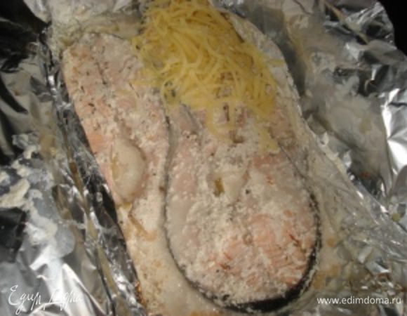 В это время натереть два вида сыра на терке и перемешать их. Спустя 30 минут, открыть фольгу, посыпать рыбу сыром и запекать еще 15 минут, но не закрывая уже фольгой.
