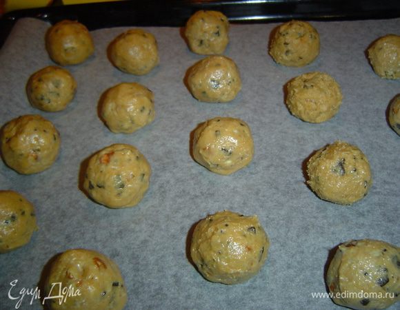 Из приготовленного теста формируем шарики, предварительно смочив руки в воде, так как тесто немного липкое. Противень застилаем пергаментной бумагой и на нее выкладываем наши шарики. Сверху можно поместить орехи.