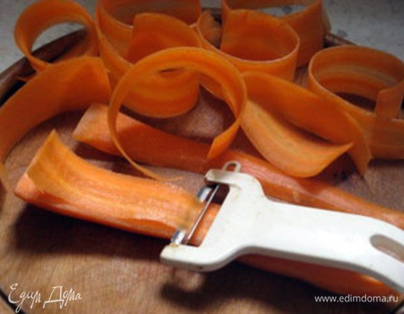 Готовый торт остудить, достать из формы и присыпать сахарной пудрой.
Приготовить морковь для украшения торта. Для этого очистить крупную морковь и нарезать её с помощью ножа для чистки картофеля на тонкие-тонкие длинные ломтики.

