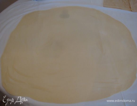 Берем 1 часть теста, посыпаем мукой и как можно тоньше раскатываем скалкой.