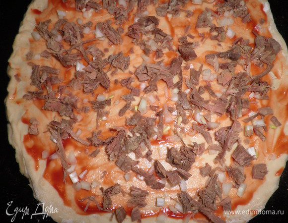 Затем тесто раскатать, на присыпанной мукой столе,в лепёшку.
Лепёшку обильно смазать кетчупом и защипить края.
На тесто выкладываем мелко прорезанный репчатый лук.Затем нарезанное мясо(чем больше тем лучше),можно сделать мясное ассорти.

