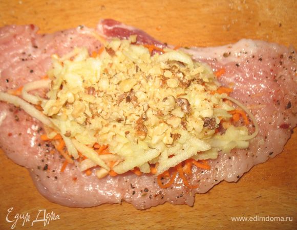 Начинаем собирать начинку. На центр кусочка мяса выкладываем морковь с сельдереем, сверху яблоки и присыпаем орехами.