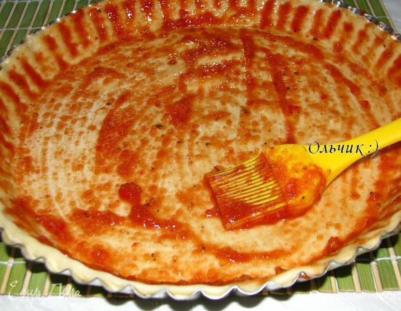 Тесто раскатываем до желаемой толщины. Выкладываем тесто в смазанную оливковым маслом форму. У меня форма рифленая, поэтому я пошла другим путем и смазала маслом тесто, что тоже замечательно сработало. При помощи кисточки смазываем тесто приготовленным соусом. Он у меня очень острый, т. к. семена из перца чили я не удаляла. 