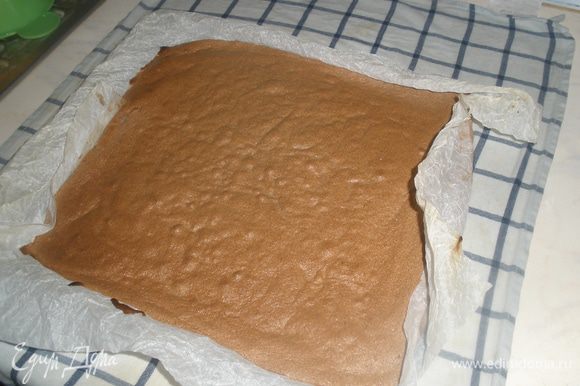 Горячий бисквит выкладываем вместе с бумагой на влажное кухонное полотенце