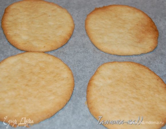 Разделить его на 3 части. Берем одну, тонко раскатываем, вырезаем 4 кружочка (я вырезала большой чашкой диаметром 12 cм). Выложить кружочки на противень, застеленный пергаментом. Выпекать при 180°С 10–15 минут. Получились у нас такие большие печенюхи. Так же поступаем и с двумя другими частями теста.