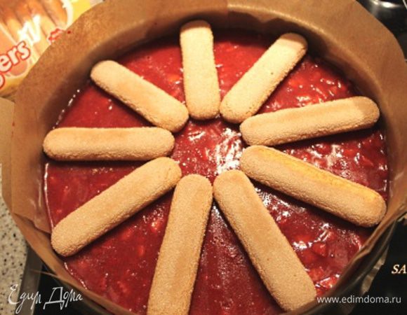 Достаём форму с бисквитом из холодильника. На желе выкладываем лучами от центра печенье Савоярди (9 штук). Печенье я ничем пропитывать не стала намеренно. Покрытое слоем суфле оно немного размягчается внутри, но корочка остаётся плотной, чего я и добивалась.