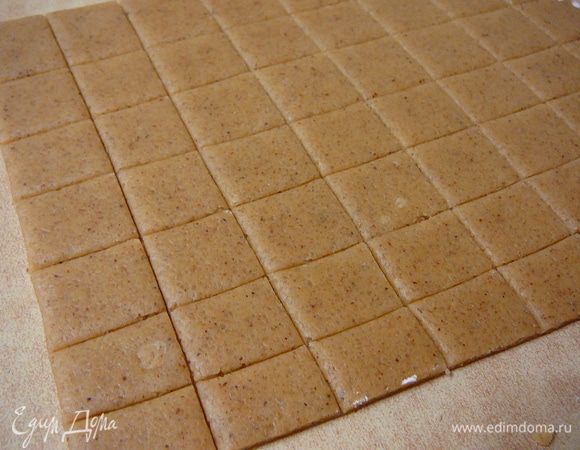 Присыпать рабочую поверхность слегка мукой и раскатать тесто толщиной в 2-3мм.Нарезать тесто на квадратики 2*2см.