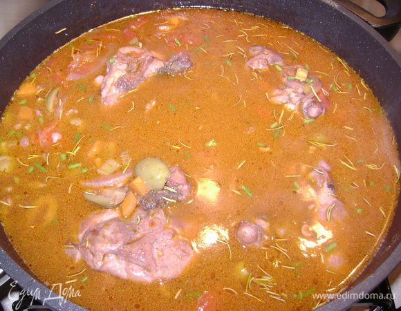 Добавить курицу и залить вином(y меня красное). 
Теперь добавьте зеленыx оливok без косточек и помидоры.
Добавьте горячую воду, практически покрывая  курицу.
Добавьте соль и перец и мелко нарезанный розмарин.
Если вы хотите, вы можете добавить мелко нарезанные стебли петрушки.Еще я добавила немного сахара и приправу для курицы.