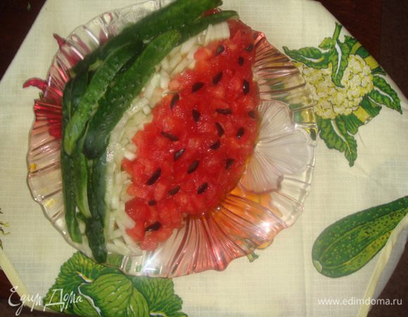 Режем помидор маленькими кусочками, с огурца снимаем кожу, режем мелко. Все выкладываем как на картинке, украшаем нарезанной маслинкой, делая из нее как бы арбузные косточки.
