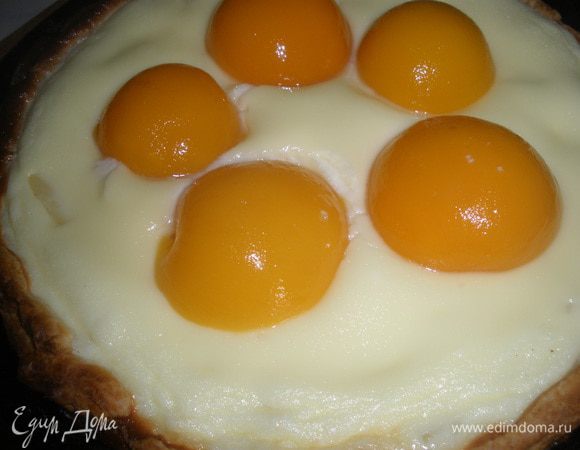 Достать пирог, выложить на него половинки персиков, присыпать пудрой и отправить еще на 10 минут в духовку, при той же температуре. 