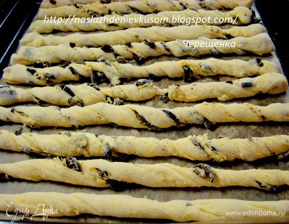 Дальше тесто сворачиваем так-же как и в первом случае, т.е. получается на первом слое начинка, а затем просто два слоя теста… Разрезаем на полоски, перекручиваем и обваливаем в кукурузной муке. Выкладываем палочки на противень, застеленный пергаментом, смазанный растительным маслом. Пергамент нужен, т.к. сыр при выпечке расплавится и может прилипнуть к противню…