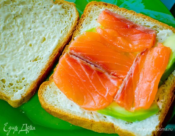 Тонко нарезанные ломтики лосося выкладываем на хлеб