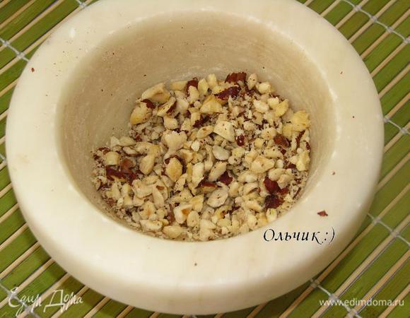 Орехи измельчаем в ступке. Но не в пыль, кусочки должны чувствоваться, так вкуснее. Добавляем в паштет, перемешиваем.