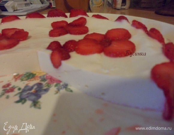 Перед подачей на стол достаем торт из емкости и украшаем дольками клубники.